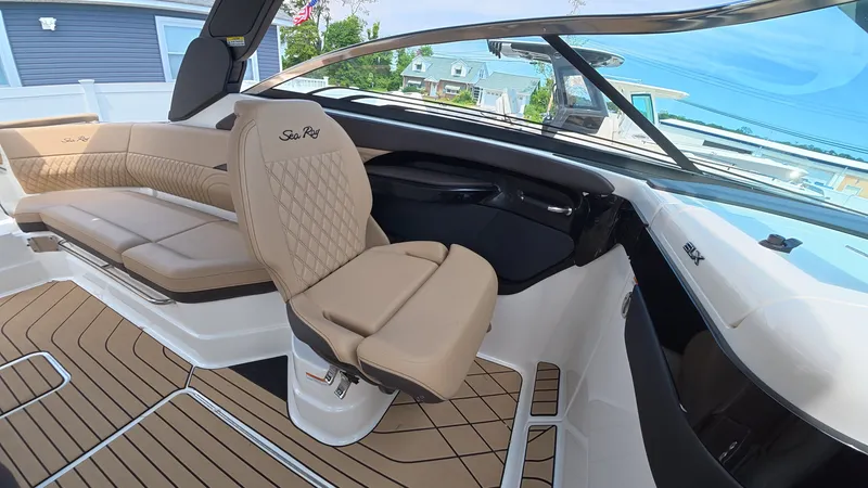 Slide: The Image of Interior of a Sea Ray SLX 280 Outboard with beige seats and wooden flooring. - 22