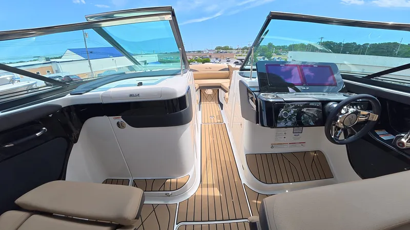 Slide: The Image of The cockpit of a modern boat with two screens and a sleek steering wheel. - 23