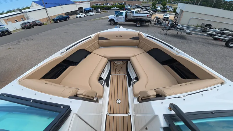 Slide: The Image of The boat features luxurious beige seating and is parked on land. - 25