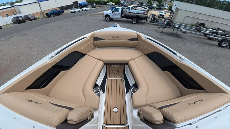 Slide: The Image of The boat features beige upholstery and is parked in a lot. - 26