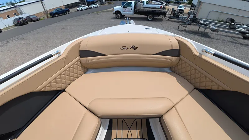 Slide: The Image of The boat features beige upholstery with 'Sea Ray' logo, parked in a lot. - 27
