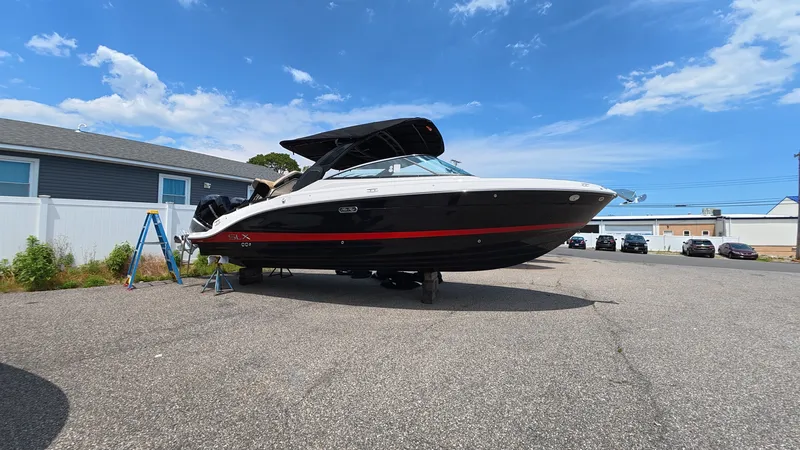 Slide: The Image of A 2026 Sea Ray SLX 280 Outboard is parked on a lot. It features a black and red design. - 36