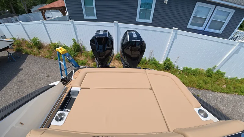 Slide: The Image of A boat with two outboard motors is parked next to a house. - 3