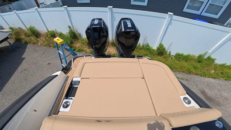 Slide: The Image of A boat with two outboard motors and a beige lounging area, surrounded by a white fence. - 4