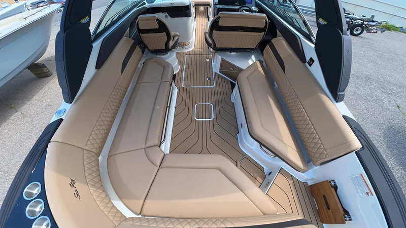 Slide: The Image of The interior of a Sea Ray SLX 280 Outboard with sleek beige seating and wooden flooring. - 5