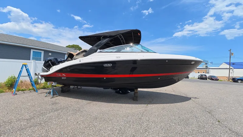 Slide: The Image of Sea Ray SLX 280 Outboard 2026 on a parking lot with blue sky. - 33