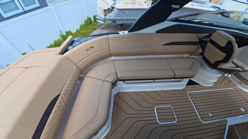 Slide: The Image of Luxurious seating area on a Sea Ray SLX 280 Outboard boat, featuring elegant upholstery and wood flooring. - 8