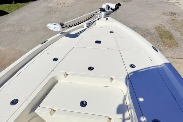 Slide: The Image of 2017 Skeeter SX240 boat deck with storage compartments and trolling motor. - 10