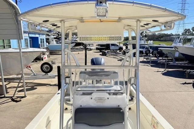 Slide: The Image of 2017 Skeeter SX240 boat with T-top, parked in a marina. - 12