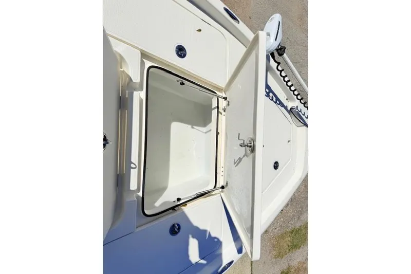 Slide: The Image of 2017 Skeeter SX240 boat storage compartment with open hatch, showcasing interior space. - 14