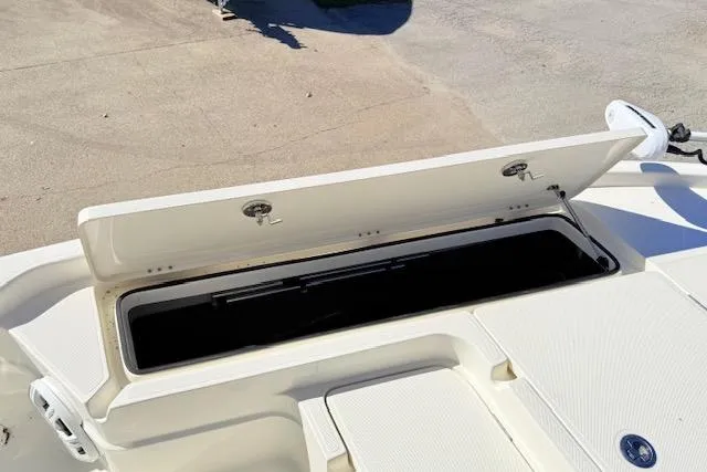 Slide: The Image of 2017 Skeeter SX240 boat storage compartment open on deck. - 15