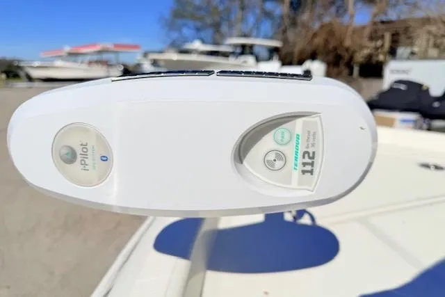 Slide: The Image of 2017 Skeeter SX240 boat with i-Pilot trolling motor, 112 thrust, in a sunny marina setting. - 16