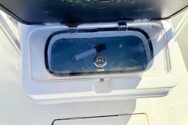 Slide: The Image of Livewell compartment on a 2017 Skeeter SX240 boat, open with visible water and aerator. - 17