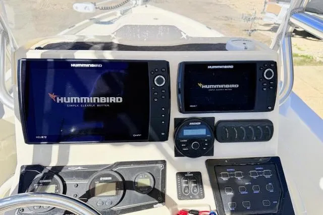 Slide: The Image of 2017 Skeeter SX240 boat dashboard with dual Humminbird displays and control panel. - 18