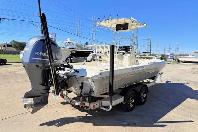 Slide: The Image of 2017 Skeeter SX240 boat on trailer with Yamaha outboard motor, parked outdoors. - 4