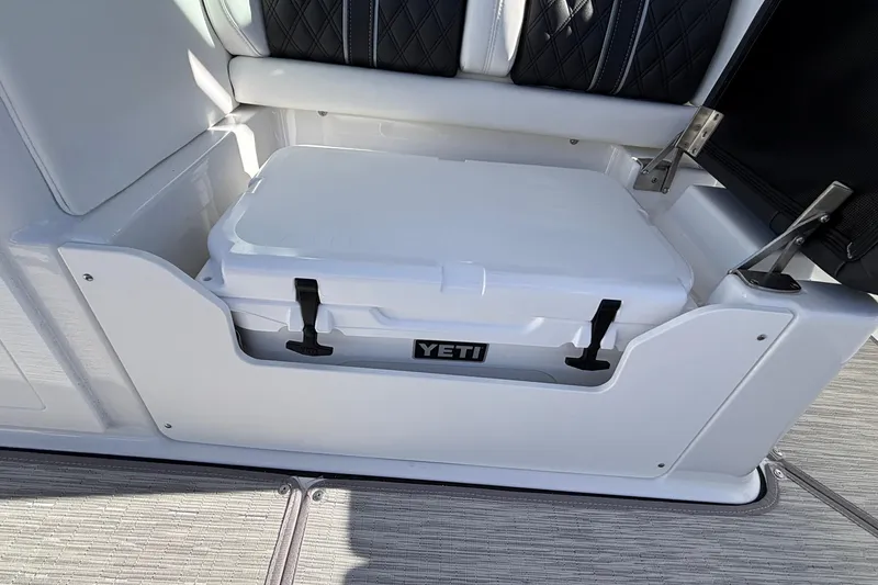 Slide: The Image of White Yeti cooler in 2026 Monterey Elite 30 OB boat storage compartment. - 13