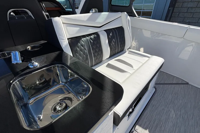 Slide: The Image of Luxurious interior of 2026 Monterey Elite 30 OB boat with sleek seating and modern sink. - 14