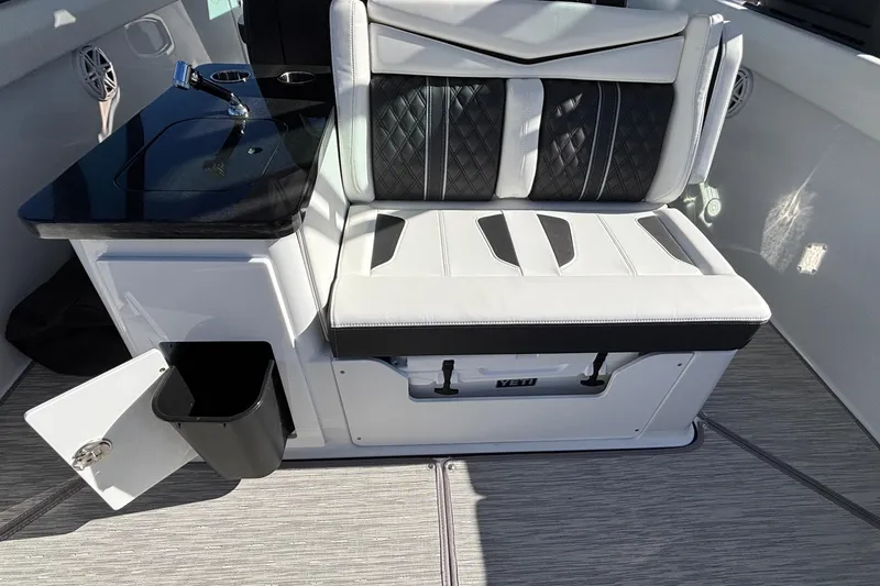 Slide: The Image of Luxury seating and kitchenette on 2026 Monterey Elite 30 OB boat, featuring sleek design and modern amenities. - 15