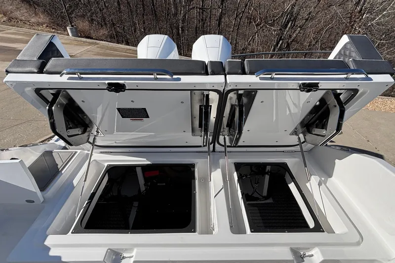 Slide: The Image of 2026 Monterey Elite 30 OB boat with open engine compartments, showcasing modern design. - 16