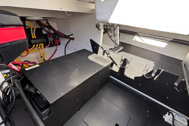 Slide: The Image of Interior view of 2026 Monterey Elite 30 OB boat, showcasing wiring and storage compartments. - 18