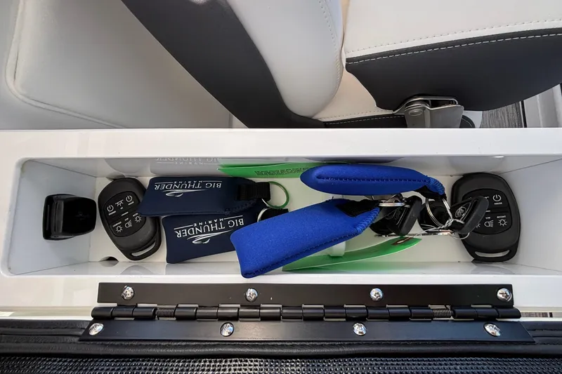 Slide: The Image of Storage compartment in 2026 Monterey Elite 30 OB boat with keys and accessories. - 28