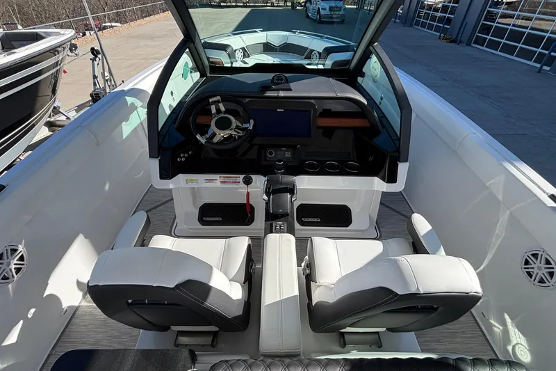 Slide: The Image of 2026 Monterey Elite 30 OB boat interior with modern dashboard and seating. - 29