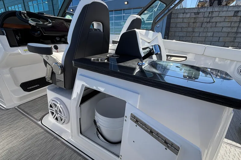 Slide: The Image of 2026 Monterey Elite 30 OB boat interior with helm, seating, and storage compartment. - 31