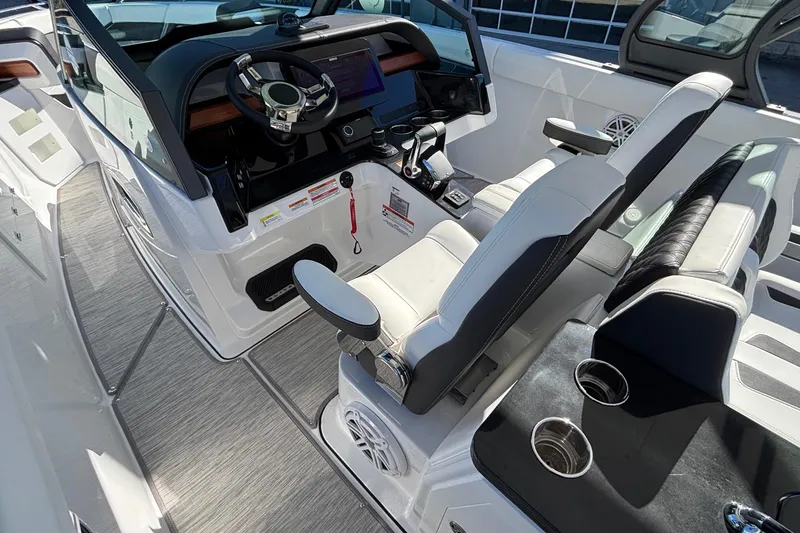 Slide: The Image of 2026 Monterey Elite 30 OB boat interior with modern helm and seating. - 32