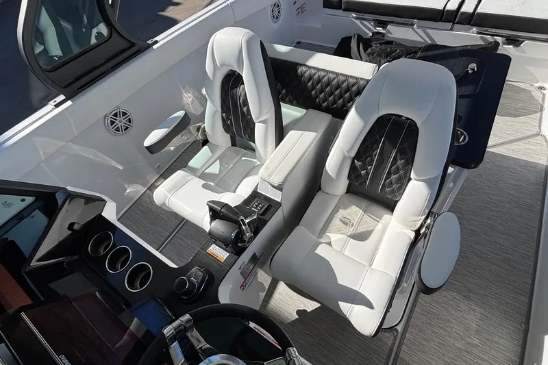 Slide: The Image of 2026 Monterey Elite 30 OB boat interior with luxurious white and black seating. - 33