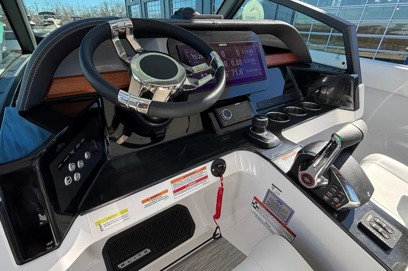 Slide: The Image of 2026 Monterey Elite 30 OB boat dashboard with modern controls and digital display. - 35