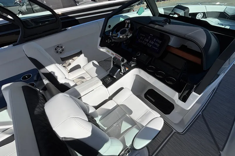 Slide: The Image of 2026 Monterey Elite 30 OB boat interior with modern dashboard and luxurious seating. - 38