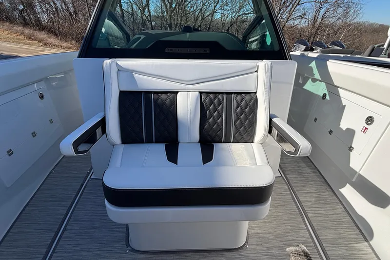 Slide: The Image of 2026 Monterey Elite 30 OB boat seat with black and white upholstery, outdoor setting. - 48