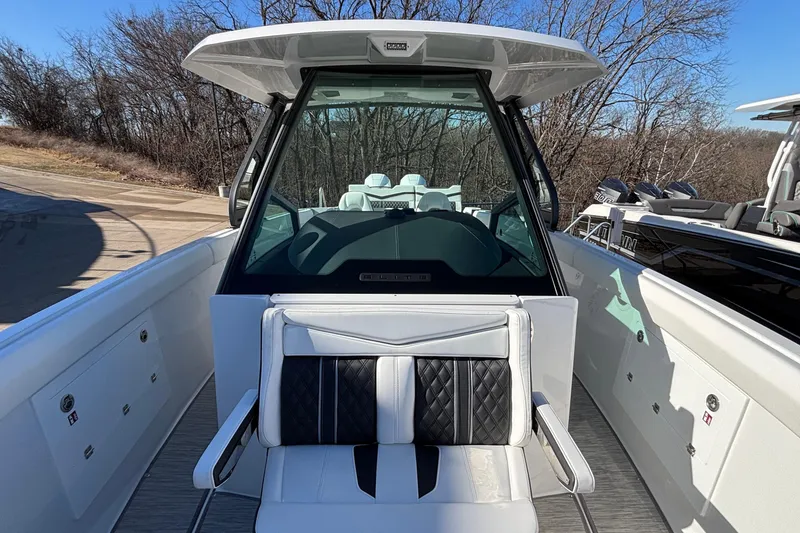 Slide: The Image of 2026 Monterey Elite 30 OB boat interior with modern seating and sleek design. - 49