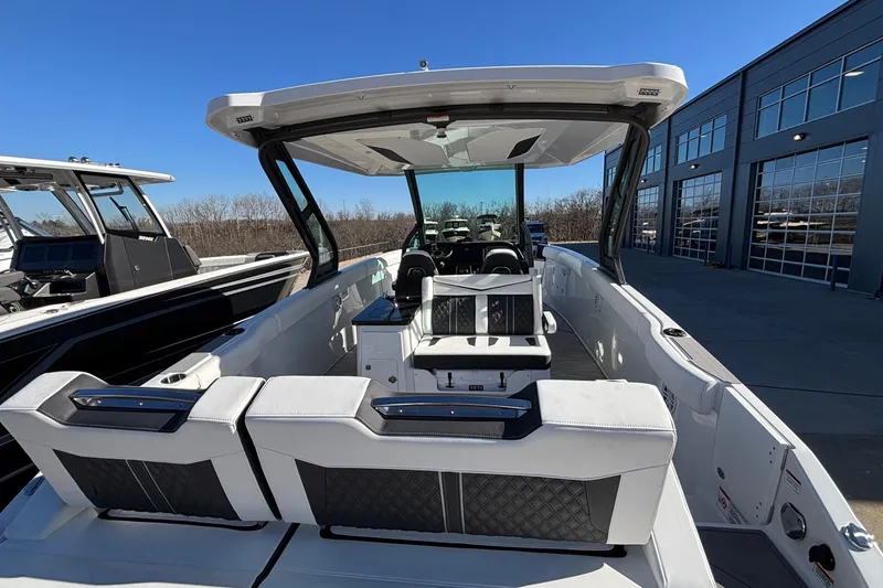 Slide: The Image of 2026 Monterey Elite 30 OB boat with sleek interior and modern design, docked outdoors. - 5