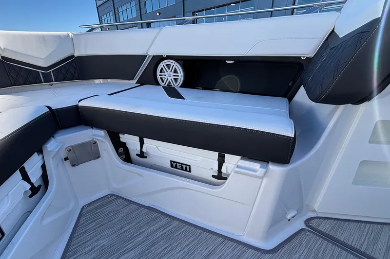 Slide: The Image of 2026 Monterey Elite 30 OB boat interior with cushioned seating and built-in Yeti cooler. - 56
