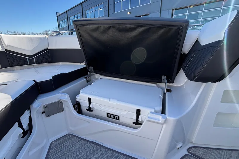 Slide: The Image of 2026 Monterey Elite 30 OB boat with Yeti cooler storage under seat. - 58