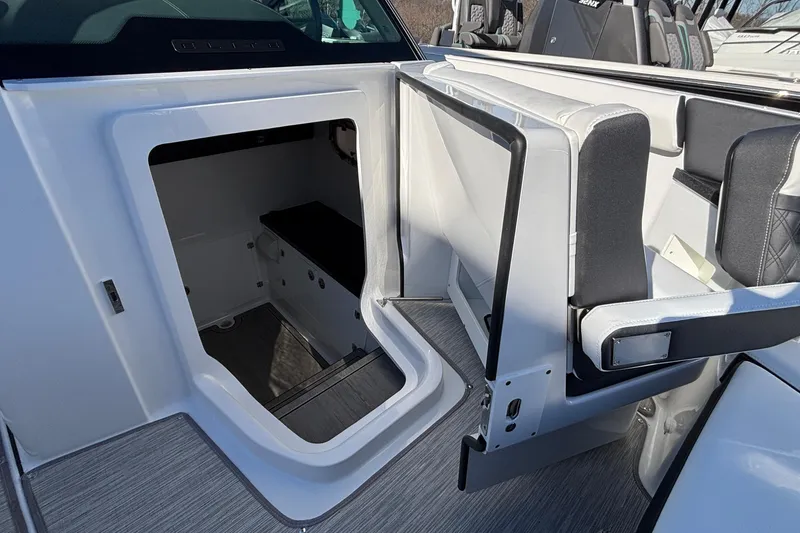 Slide: The Image of 2026 Monterey Elite 30 OB boat interior with open storage compartment and seating. - 61