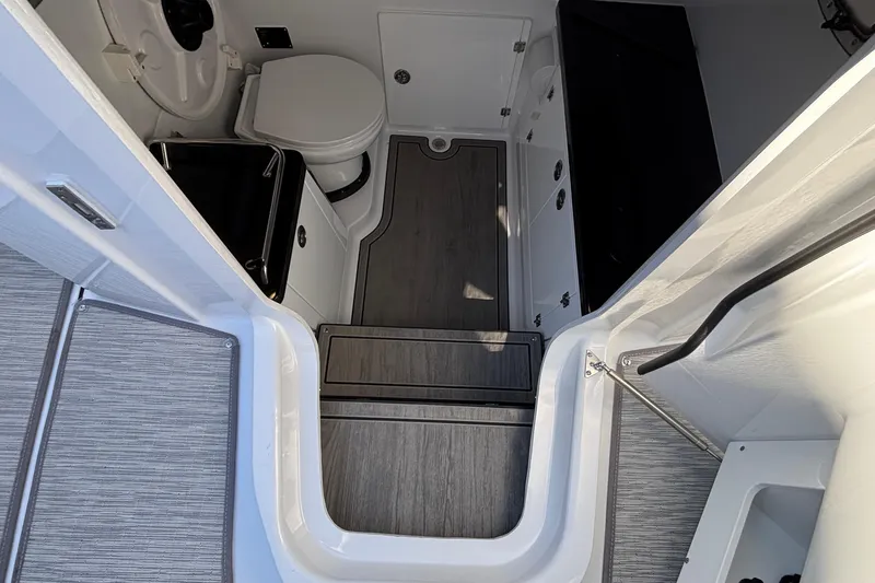 Slide: The Image of 2026 Monterey Elite 30 OB boat interior with modern bathroom and sleek flooring. - 62