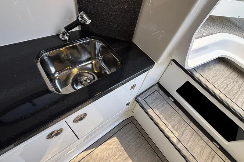Slide: The Image of Modern kitchenette in 2026 Monterey Elite 30 OB boat with sleek sink and cabinetry. - 68