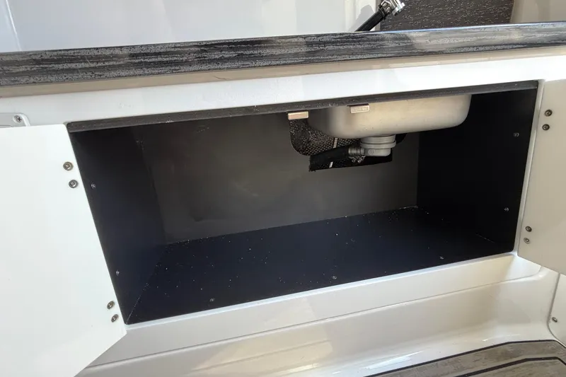 Slide: The Image of Open storage compartment under sink in 2026 Monterey Elite 30 OB boat. - 69