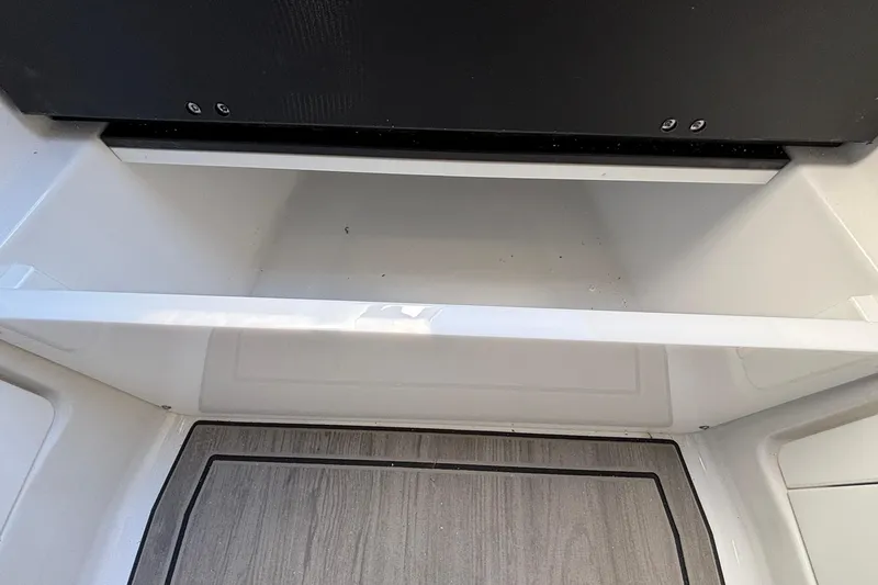 Slide: The Image of Open storage compartment in 2026 Monterey Elite 30 OB boat interior. - 71