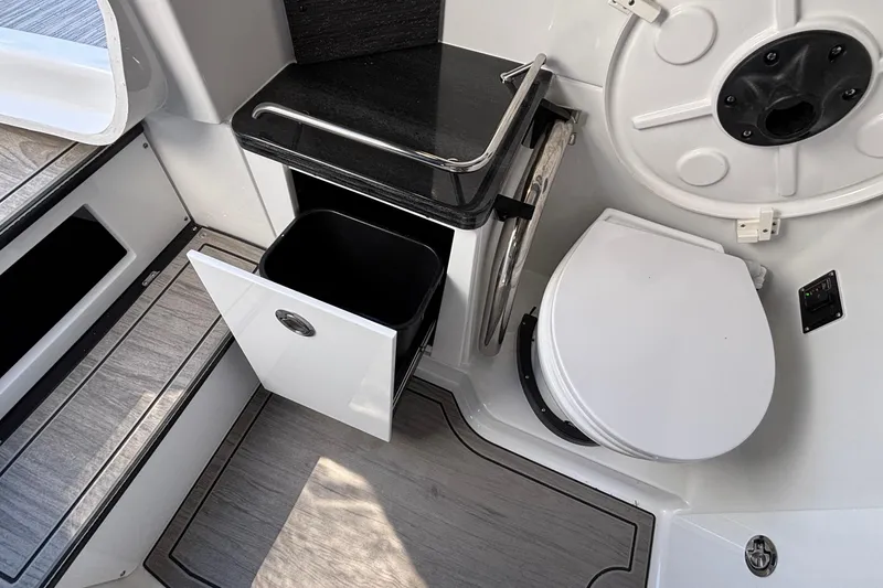 Slide: The Image of 2026 Monterey Elite 30 OB boat interior with toilet and storage cabinet. - 72