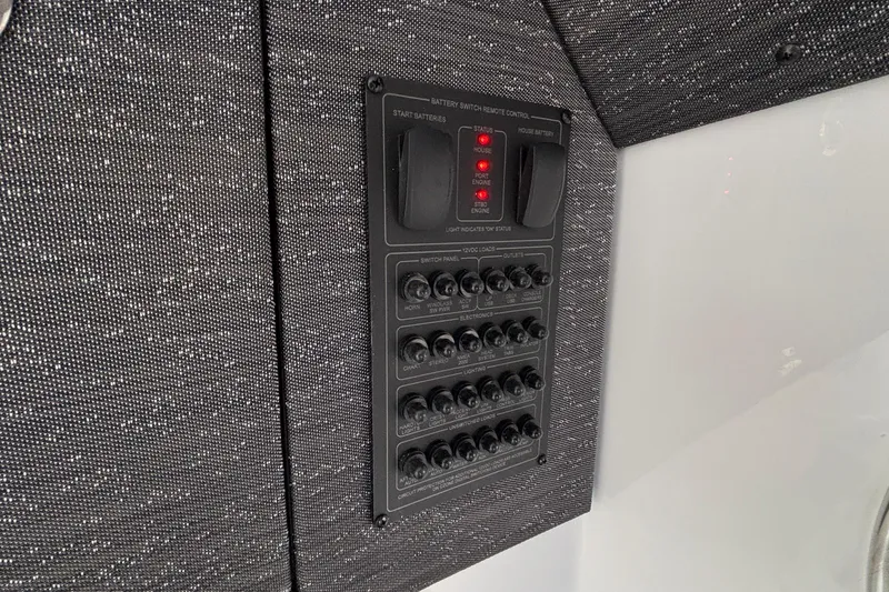 Slide: The Image of Control panel on 2026 Monterey Elite 30 OB boat, featuring switches and indicators. - 74