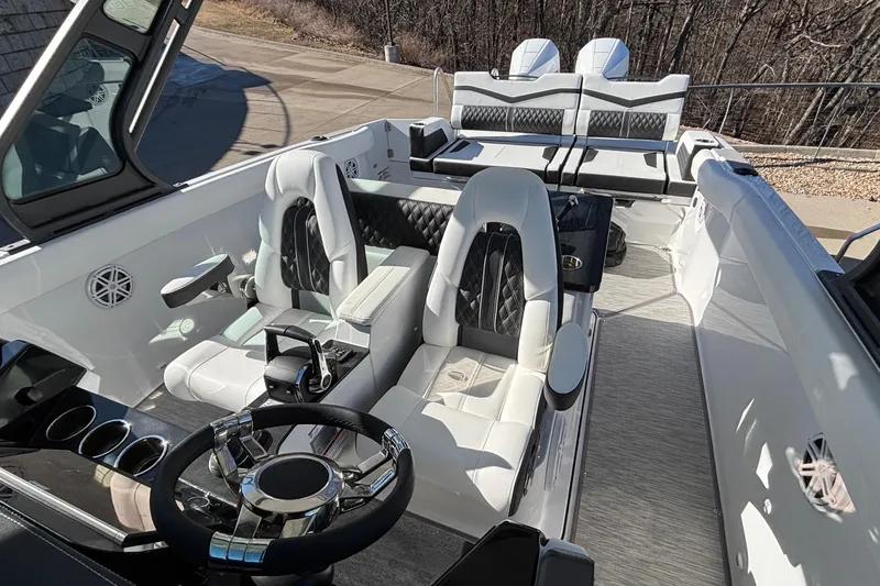 Slide: The Image of 2026 Monterey Elite 30 OB boat interior with luxurious seating and modern steering wheel. - 75