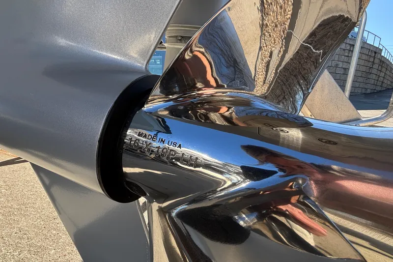 Slide: The Image of Close-up of a shiny propeller on a 2026 Monterey Elite 30 OB boat. - 77