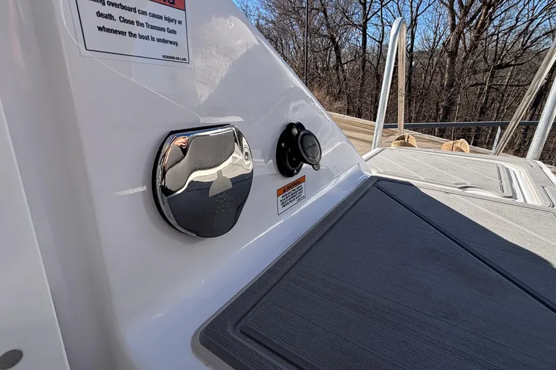 Slide: The Image of 2026 Monterey Elite 30 OB boat deck with safety warning and chrome fixture. - 9