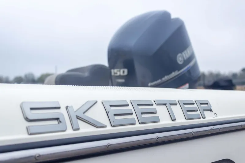Slide: The Image of 2013 Skeeter SX210 boat with Yamaha 150 engine in focus. - 11
