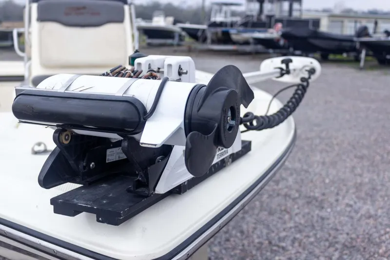 Slide: The Image of 2013 Skeeter SX210 boat with trolling motor on deck, parked outdoors. - 14