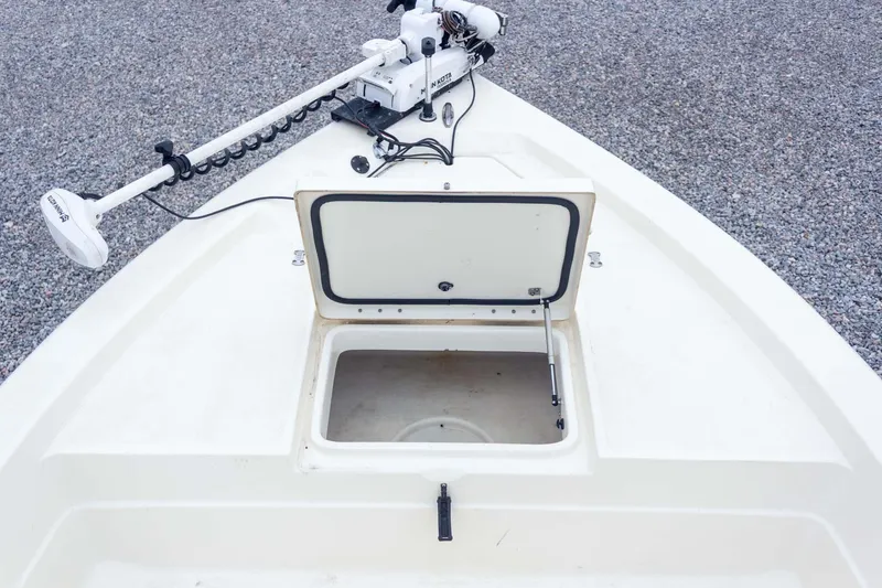 Slide: The Image of 2013 Skeeter SX210 boat with open storage compartment and trolling motor. - 17