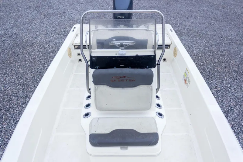 Slide: The Image of 2013 Skeeter SX210 boat interior with console and seating, viewed from above. - 19
